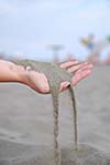 fine sand leaking trought woman hands