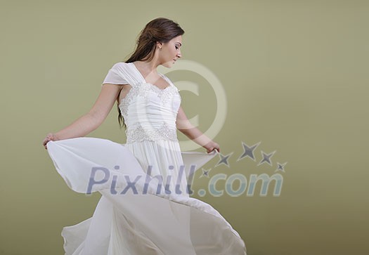 Portrait of a beautiful woman dressed as a bride isolated on white background in studio