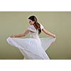 Portrait of a beautiful woman dressed as a bride isolated on white background in studio