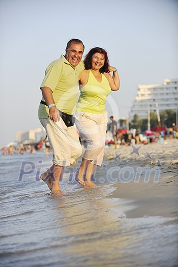 happy senior mature elderly people couple have romantic time on beach at sunset happy senior mature elderly people couple have romantic time on beach at sunset