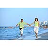 happy senior mature elderly people couple have romantic time on beach at sunset 