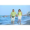 happy senior mature elderly people couple have romantic time on beach at sunset 