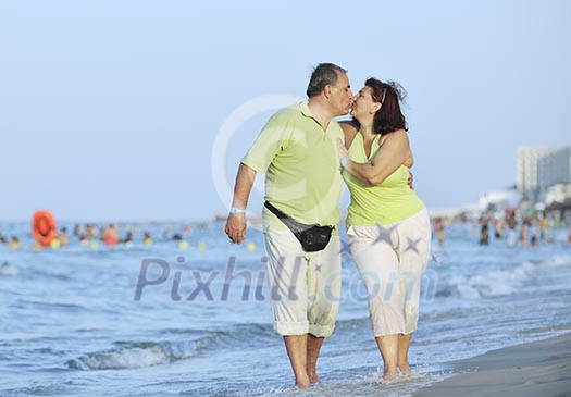 happy senior mature elderly people couple have romantic time on beach at sunset happy senior mature elderly people couple have romantic time on beach at sunset