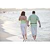 happy senior mature elderly people couple have romantic time on beach at sunset 