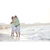 happy senior mature elderly people couple have romantic time on beach at sunset 