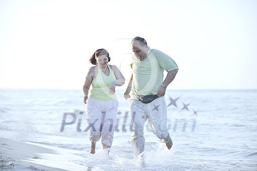 happy senior mature elderly people couple have romantic time on beach at sunset happy senior mature elderly people couple have romantic time on beach at sunset