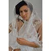 Portrait of a beautiful woman dressed as a bride isolated on white background in studio