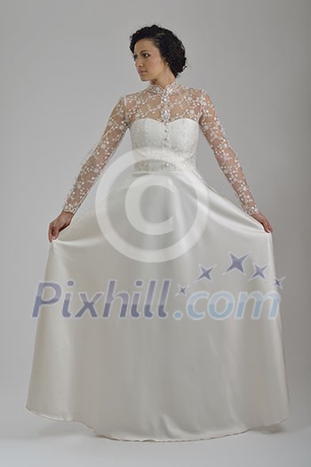 Portrait of a beautiful woman dressed as a bride isolated on white background in studio Portrait of a beautiful woman dressed as a bride isolated on white background in studio