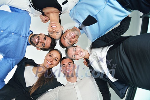 Closeup of happy business people with their heads together representing concept of ftiendship and teamwork isolated on white background Closeup of happy business people with their heads together representing concept of ftiendship and teamwork isolated on white background