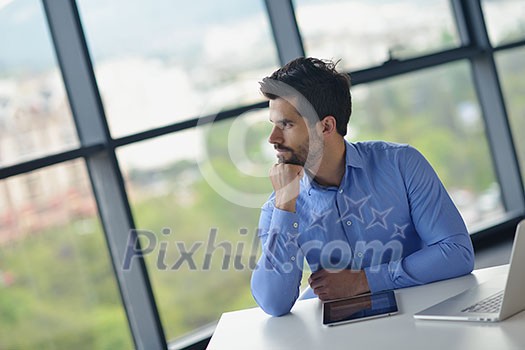 happy young business man work in modern office on computer happy young business man work in modern office on computer