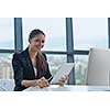 portrait of Young pretty business woman work on  notebook computer  in the bright modern office indoors