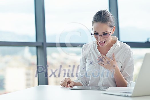 portrait of Young pretty business woman work on notebook computer in the bright modern office indoors portrait of Young pretty business woman work on notebook computer in the bright modern office indoors