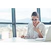 portrait of Young pretty business woman work on  notebook computer  in the bright modern office indoors