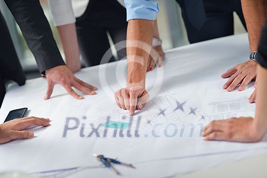 business people group on meeting and presentation in bright modern office with construction engineer architect and worker looking building model and blueprint planbleprint plans business people group on meeting and presentation in bright modern office with construction engineer architect and worker looking building model and blueprint planbleprint plans