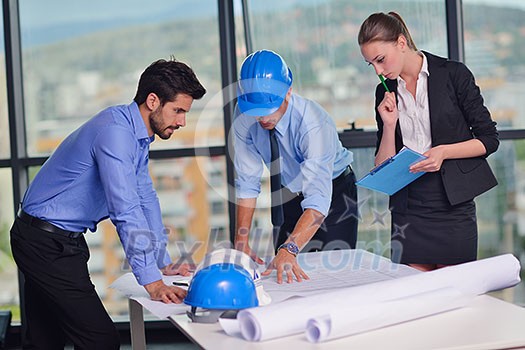 business people group on meeting and presentation in bright modern office with construction engineer architect and worker looking building model and blueprint planbleprint plans business people group on meeting and presentation in bright modern office with construction engineer architect and worker looking building model and blueprint planbleprint plans