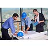 business people group on meeting and presentation  in bright modern office with construction engineer architect and worker looking building model and blueprint planbleprint plans