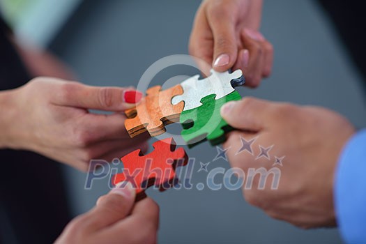Group of business people assembling jigsaw puzzle and represent team support and help concept Group of business people assembling jigsaw puzzle and represent team support and help concept