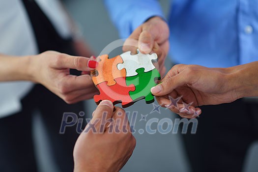 Group of business people assembling jigsaw puzzle and represent team support and help concept Group of business people assembling jigsaw puzzle and represent team support and help concept