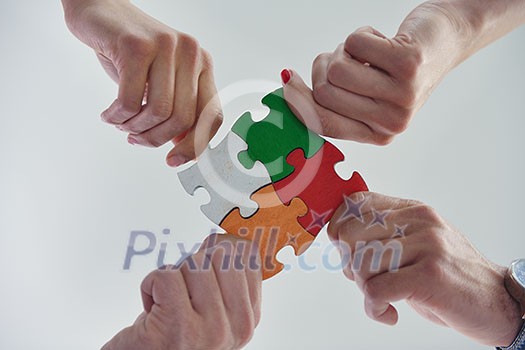 Group of business people assembling jigsaw puzzle and represent team support and help concept Group of business people assembling jigsaw puzzle and represent team support and help concept