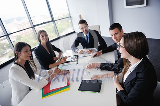 Group of happy young business people in a meeting at office Group of happy young business people in a meeting at office