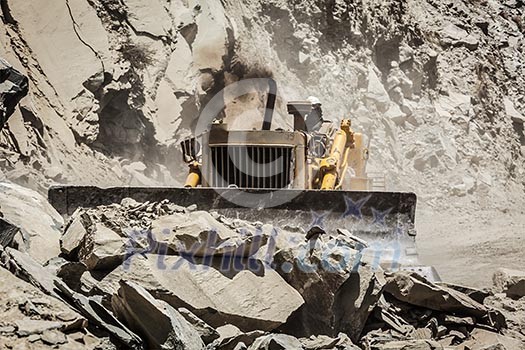 Bulldozer doing mountain road construction in Himalayas. Himachal Pradesh, India Bulldozer doing mountain road construction in Himalayas. Himachal Pradesh, India