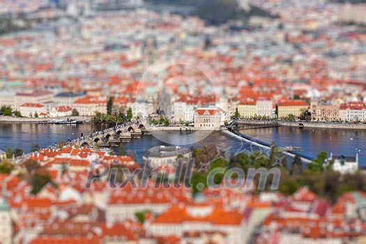 Aerial view of Charles Bridge over Vltava river and Old city from Petrin hill Observation Tower with tilt shift toy effect shallow depth of field. Prague, Czech Republic Aerial view of Charles Bridge over Vltava river and Old city from Petrin hill Observation Tower with tilt shift toy effect shallow depth of field. Prague, Czech Republic