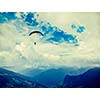 Vintage retro effect filtered hipster style travel image of freedom flight concept - paraplane in sky above Himalayas mountains