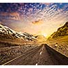Road in Himalayas mountains on sunset