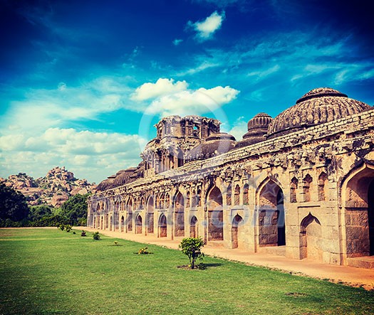 Vintage retro effect filtered hipster style travel image of Ancient ruins of Elephant Stables, Royal Centre. Hampi, Karnataka, India. Stitched panorama Vintage retro effect filtered hipster style travel image of Ancient ruins of Elephant Stables, Royal Centre. Hampi, Karnataka, India. Stitched panorama