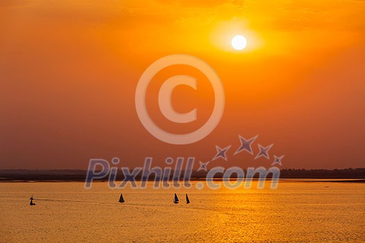 Yacht boats silhouettes in lake on sunset Yacht boats silhouettes in lake on sunset