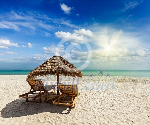 Two beach lounge chairs under tent on beach. Sihanoukville, Cambodia Two beach lounge chairs under tent on beach. Sihanoukville, Cambodia