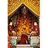 Buddhist monk praying in Shwedagon Paya pagoda. Yangon, Myanmar