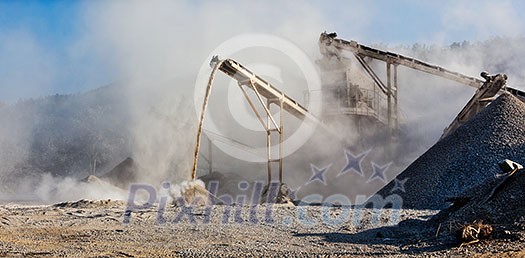 Industrial background - crusher rock stone crushing machine at open pit mining and processing plant for crushed stone, sand and gravel Industrial background - crusher rock stone crushing machine at open pit mining and processing plant for crushed stone, sand and gravel