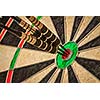 Success hitting target aim goal achievement concept background - three darts in bull's eye close up