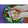 spa and beauty female hand and flower in water