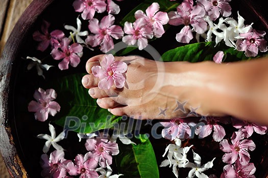 Closeup photo of a woman feet at spa salon on pedicure procedure. Legs care concept Closeup photo of a woman feet at spa salon on pedicure procedure. Legs care concept
