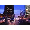 busy traffic scene of street in night  with car traffic and vivid colored city scene