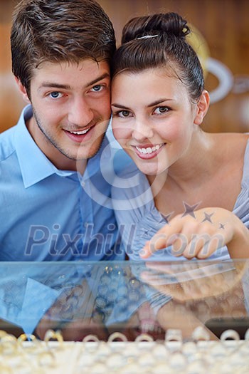 happy young romantic couple in love buy jewelry ring in luxury store happy young romantic couple in love buy jewelry ring in luxury store