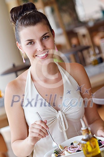A young couple sitting at a table and have lunch at an outdoor restaurant A young couple sitting at a table and have lunch at an outdoor restaurant