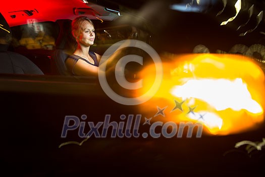 Driving a car at night - pretty, young woman driving her modern car at night, in a city (shallow DOF; color toned image) Driving a car at night - pretty, young woman driving her modern car at night, in a city (shallow DOF; color toned image)