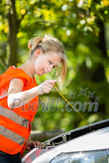 Young female driver wearing a high visibility vest on the roadside after her car has broken down Young female driver wearing a high visibility vest on the roadside after her car has broken down