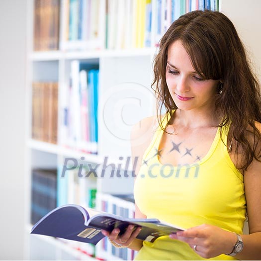 Pretty young college student in a library (shallow DOF; color toned image) Pretty young college student in a library (shallow DOF; color toned image)