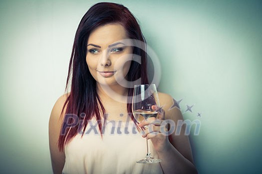 Pretty, young woman having a glass of wine (color toned image) Pretty, young woman having a glass of wine (color toned image)