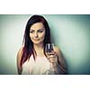 Pretty, young woman having a glass of wine (color toned image)