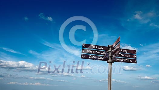 Signpost with directional signs in sky with clouds Signpost with directional signs in sky with clouds