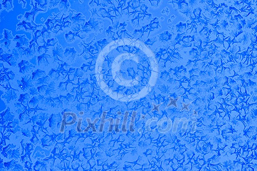 Frost patterns on window glass in winter Frost patterns on window glass in winter