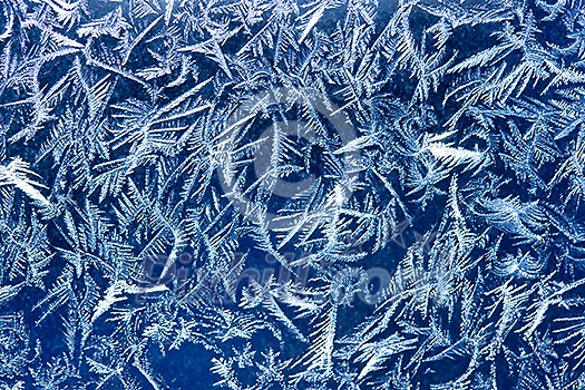 Frost patterns on window glass in winter Frost patterns on window glass in winter
