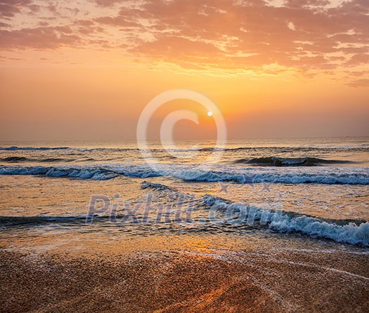 Sunrise on beach with dramatic sky Sunrise on beach with dramatic sky