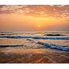 Sunrise on beach with dramatic sky