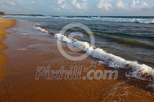 Wave surging on sand on beach Wave surging on sand on beach
